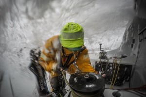 Leg 9, from Newport to Cardiff, day 2 on board Team AkzoNobel. Water pours over the deck as Chris Nicholson eases the sails