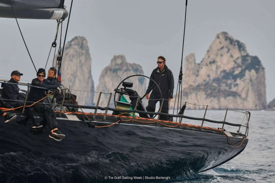 Tactician Ken Read directs the 100ft V past Capri's Faraglioni rocks. Photo: Tre Golfi Sailing Week/Studio Borlenghi