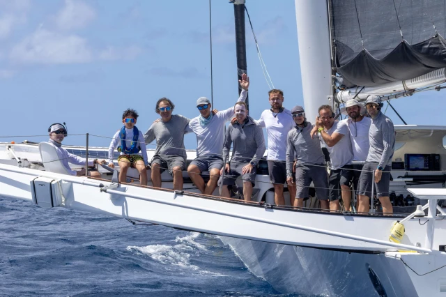 Jason Carroll (on the helm) and his victorious, record-breaking crew of the MOD70 Argo. Photo: Tim Wright / www.photoaction.com / RORC